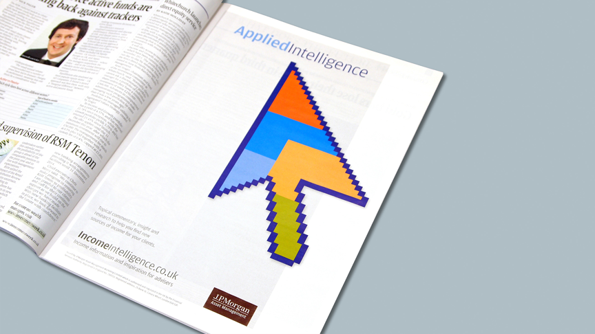 open magazine with page showing stylised and coloured mouse cursor with heading above and jp morgan logo below